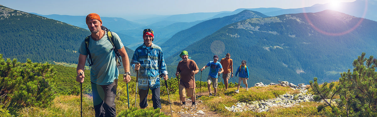 Group of hikers on a mountain trail with scenic background