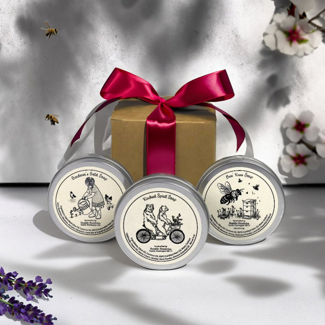 three Seattle Sundries soaps in tins with a gift box