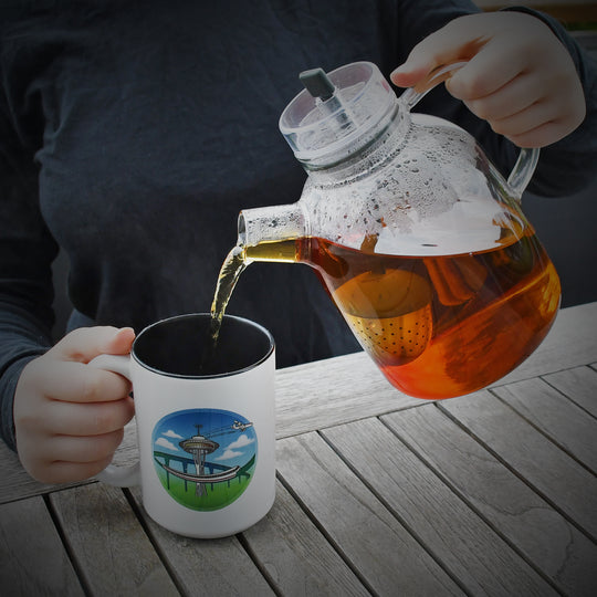 demo hands pouring tea 15oz ceramic Jet City Seattle space needle monorail Boeing airplane mug